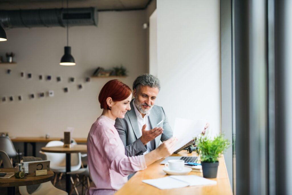 Two people reviewing information together at a table.