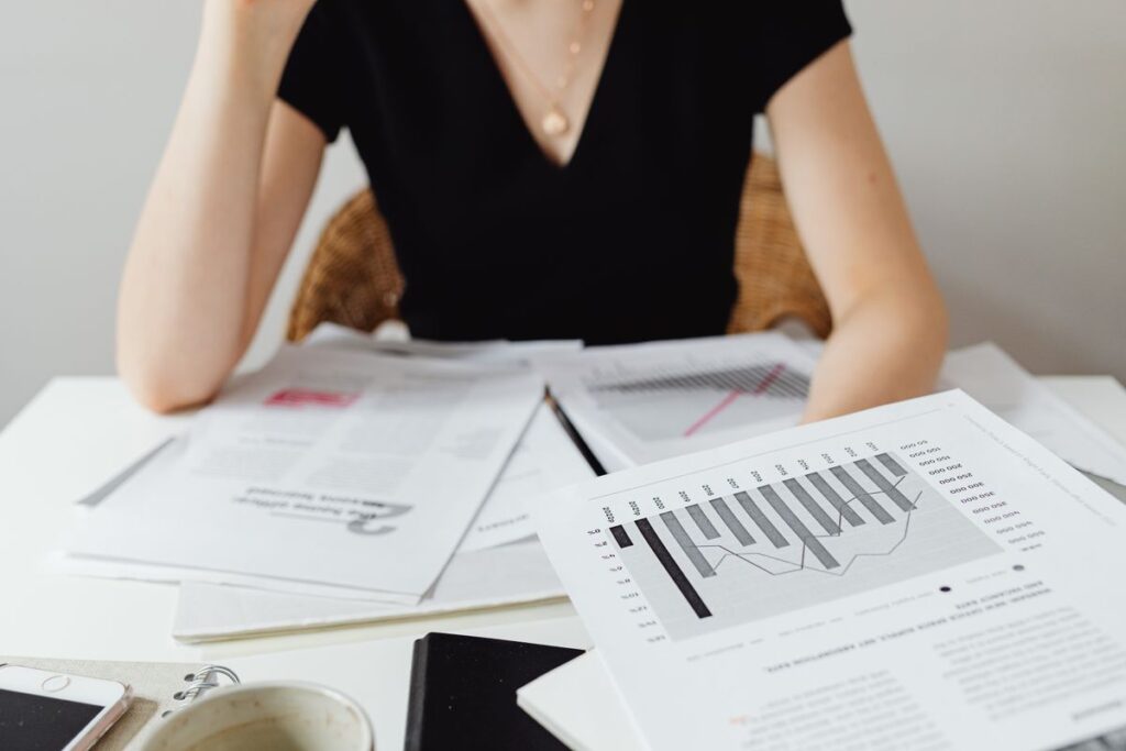 Printed charts and reports spread across a desk during a review